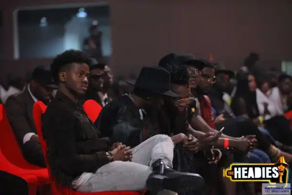 What Is Reekado Showing Lil Kesh In This Photo?